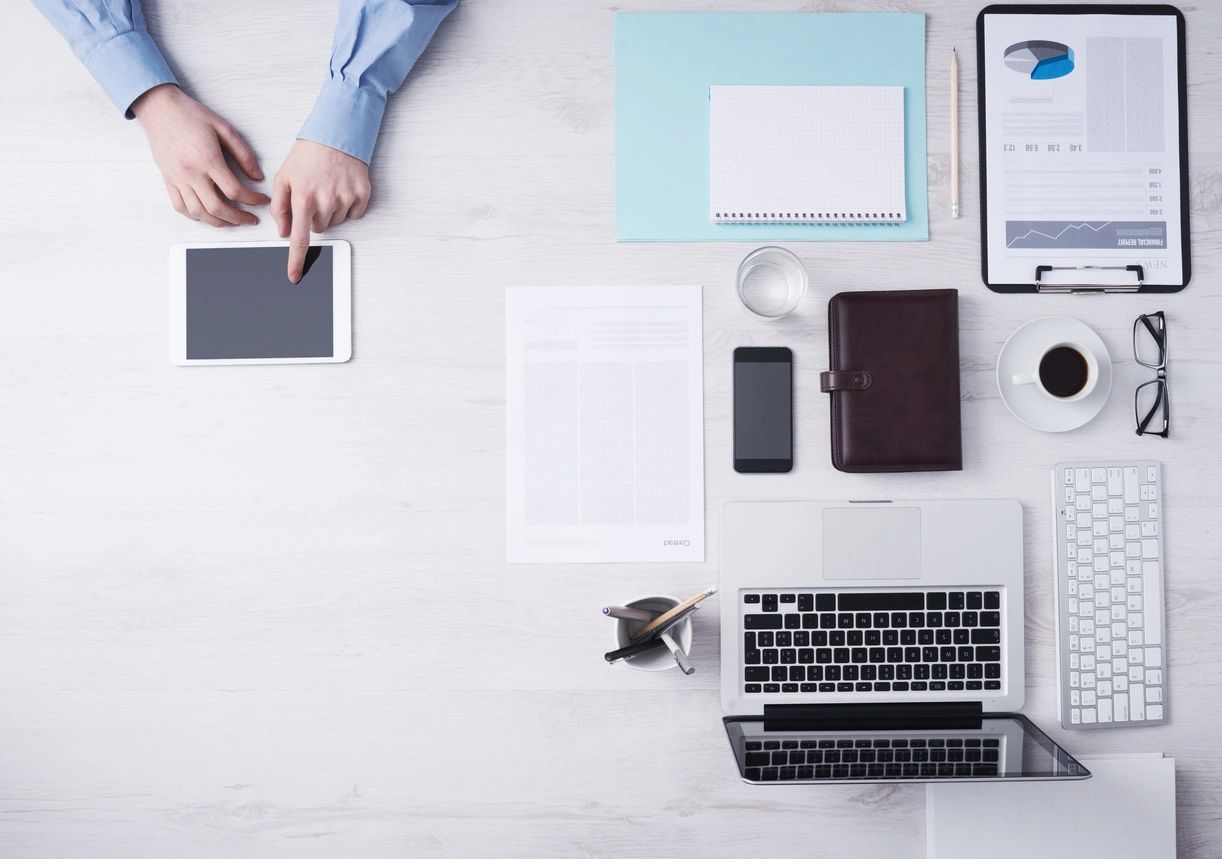 desk with laptop notebook papers