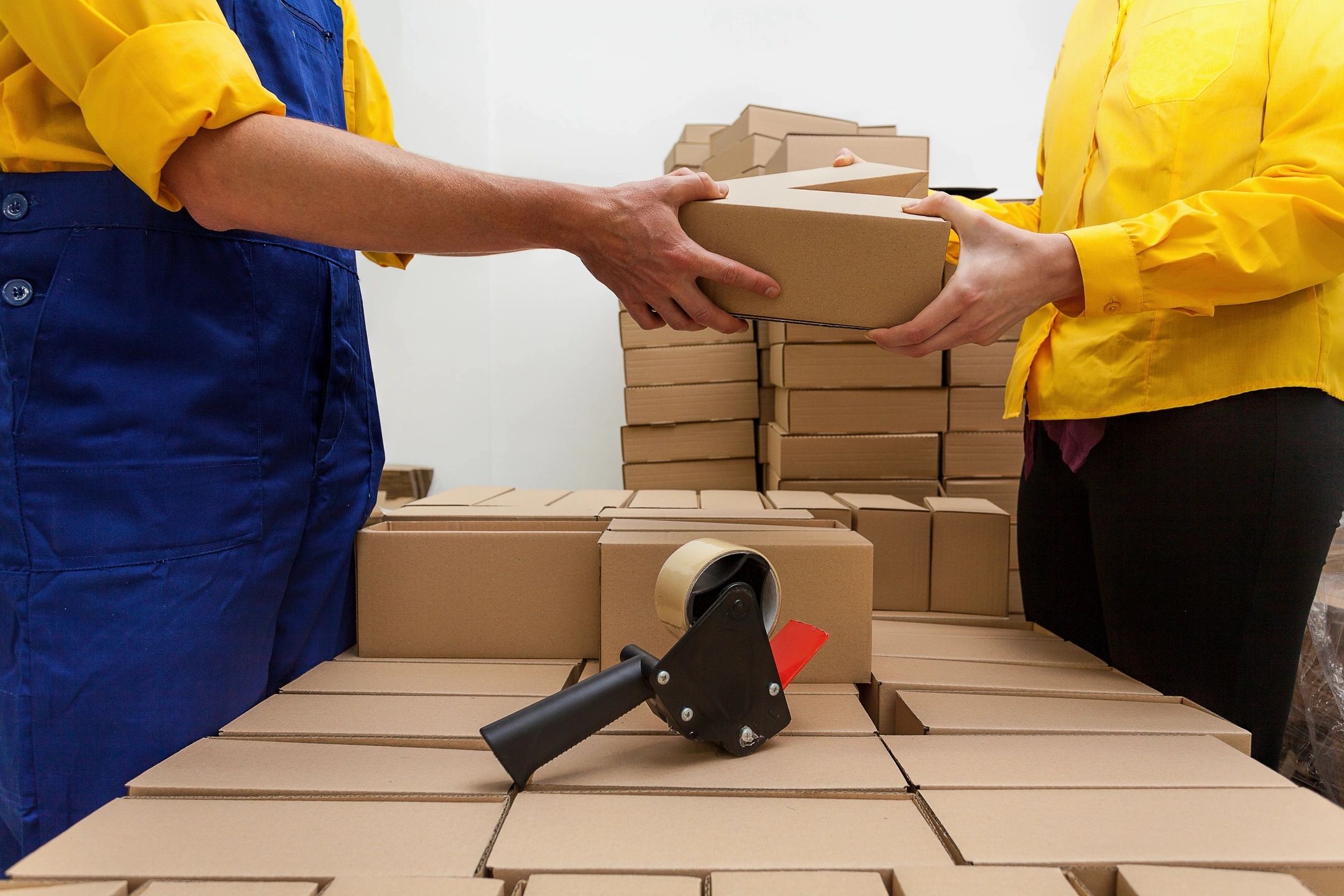 shipping boxes two persons exchanging a package